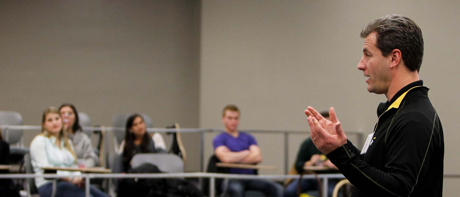 EY employee speaks to a class filled with RBC students