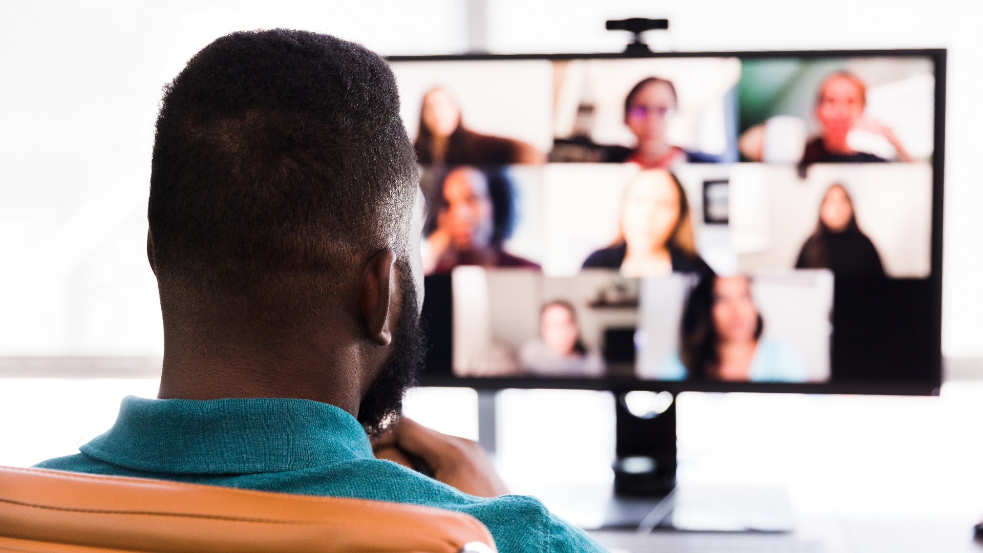 A mid meets with his colleagues during a video conference.
