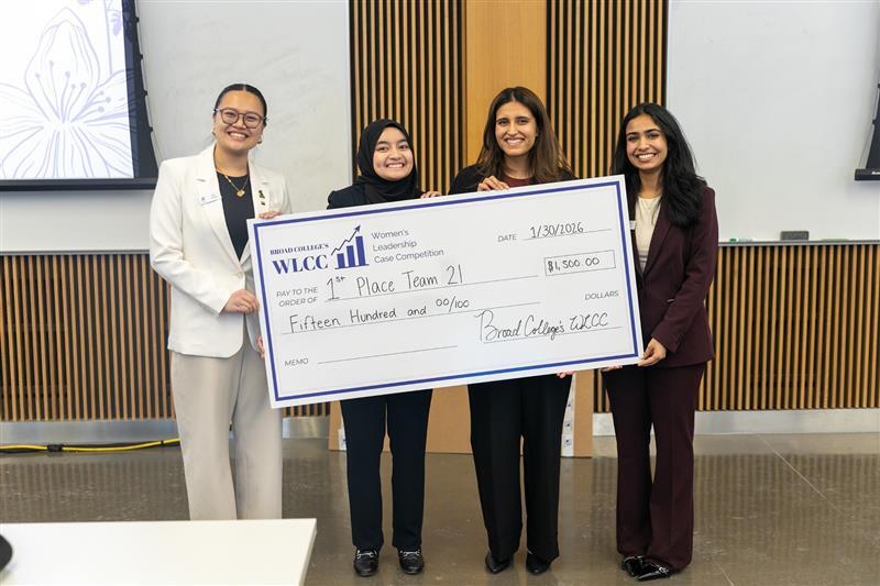 Junior/Senior winners holding oversized check