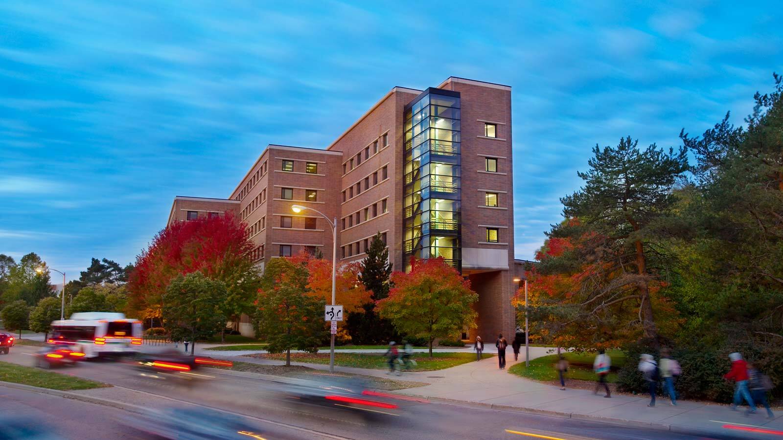 The Business College Complex exterior as seen at dusk.