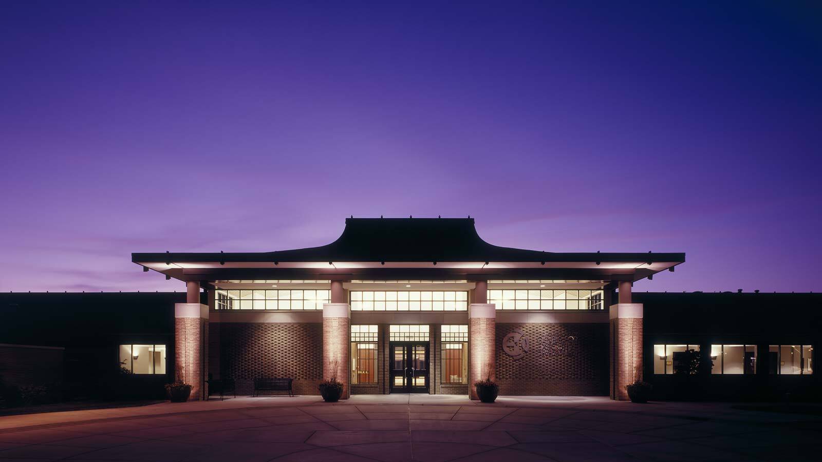 The front exterior entrance to the Henry Center for Executive Development, as seen at night.