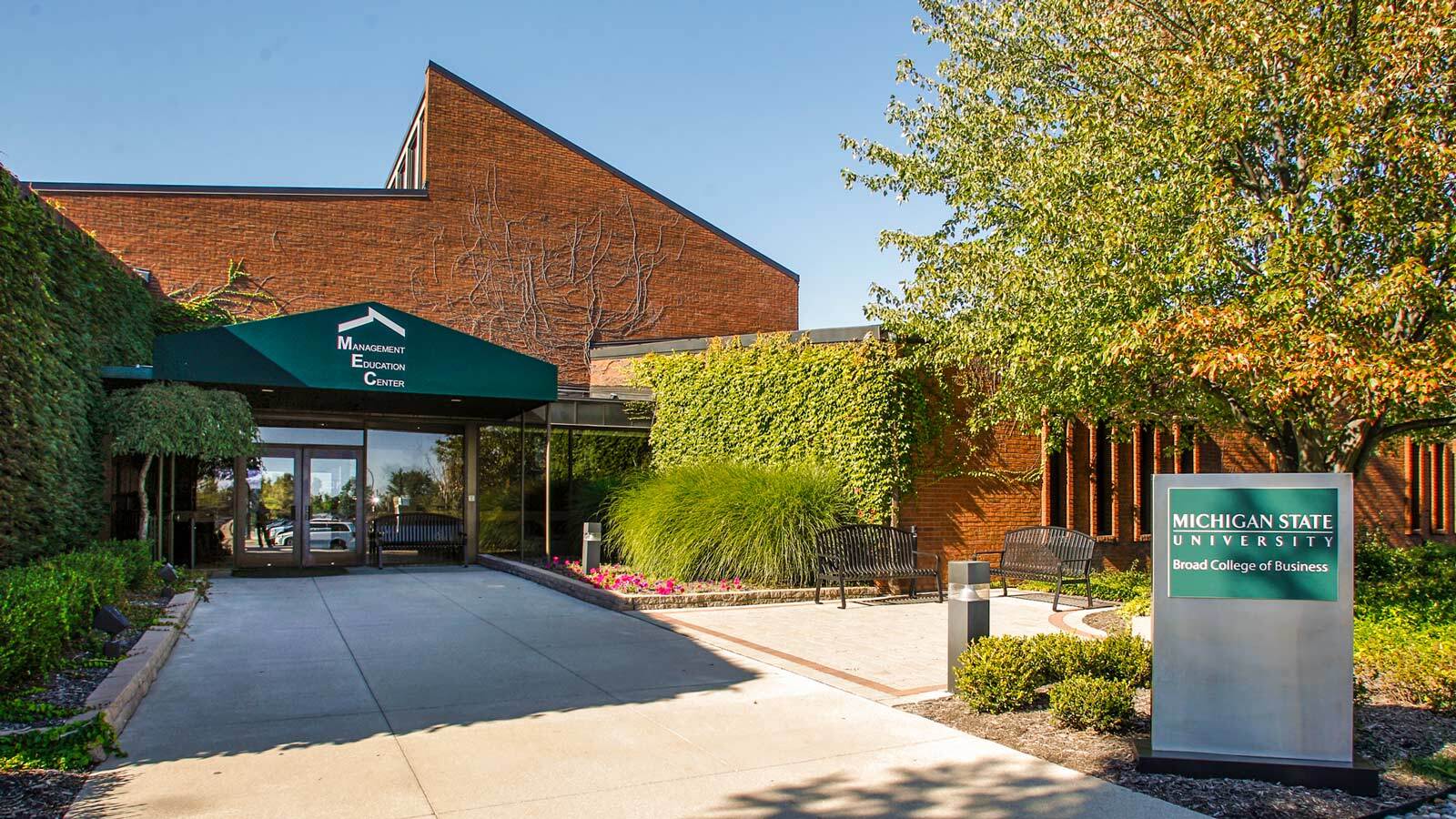 Front exterior entrance to the Management Education Center (MEC) in Troy, Michigan, as seen on a sunny summer day.