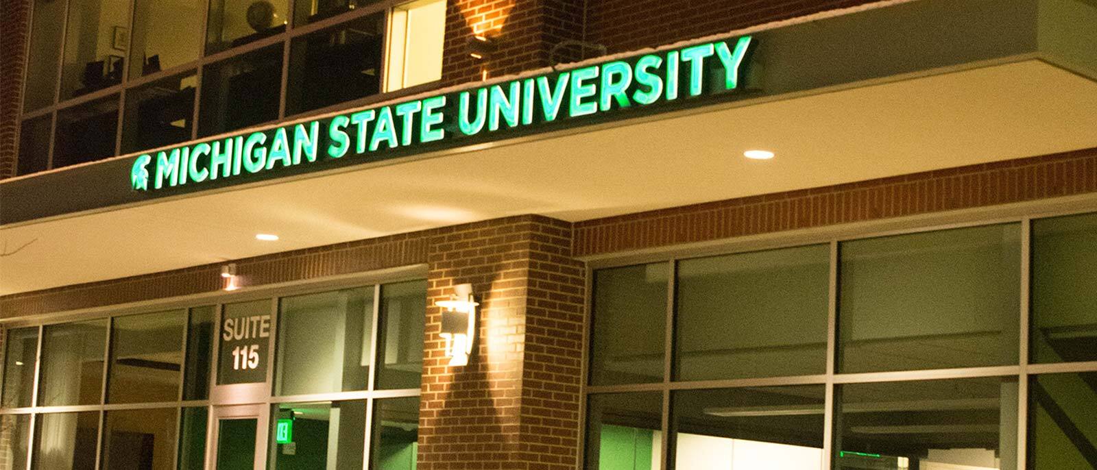 The exterior of the Axia Institute lit up at night in Midland, Michigan.