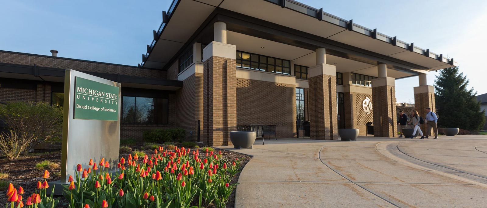 Front entrance of the James B. Henry Center for Executive Development, as seen on a sunny summer day.