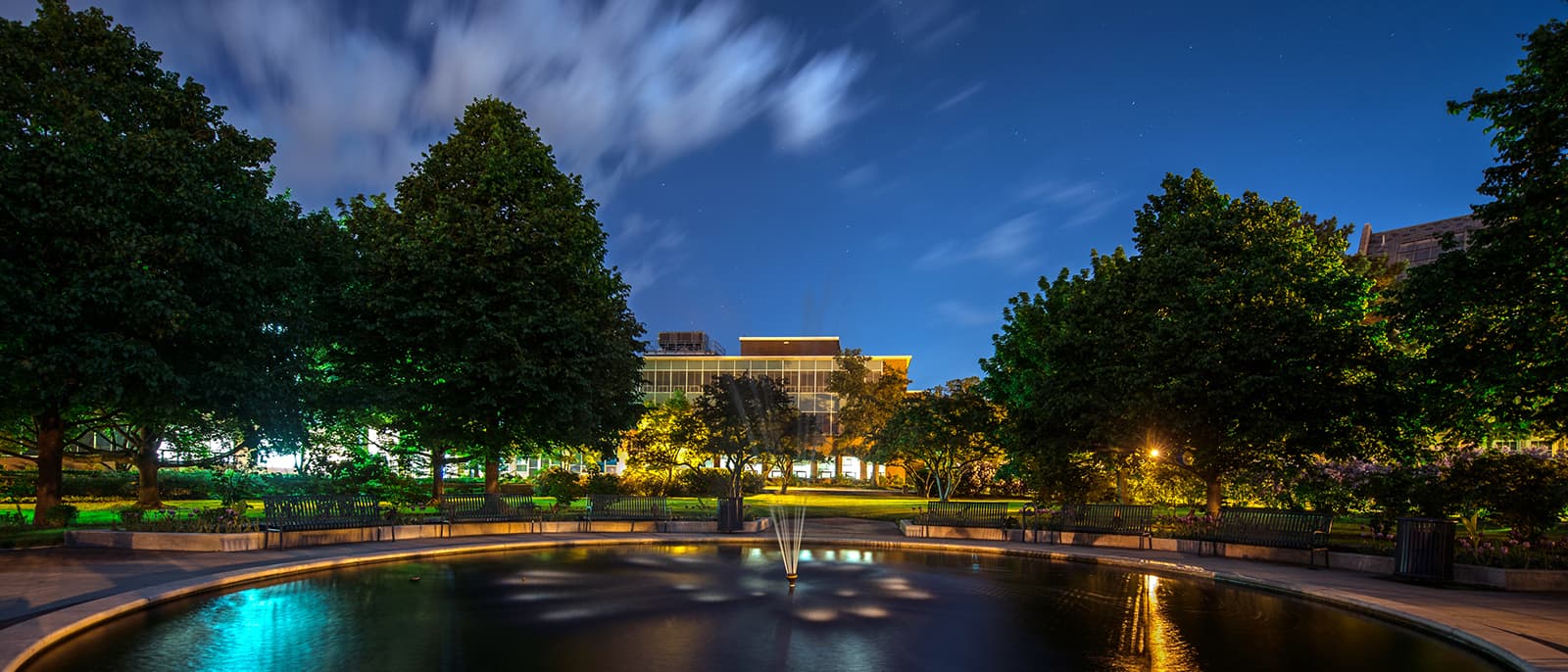 Fountain outside Student Services building on MSU campus, as seen lit up at night.
