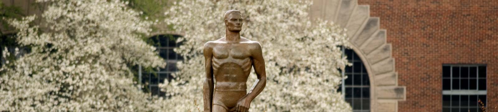 Spartan Statue on a spring day with trees blooming in the background