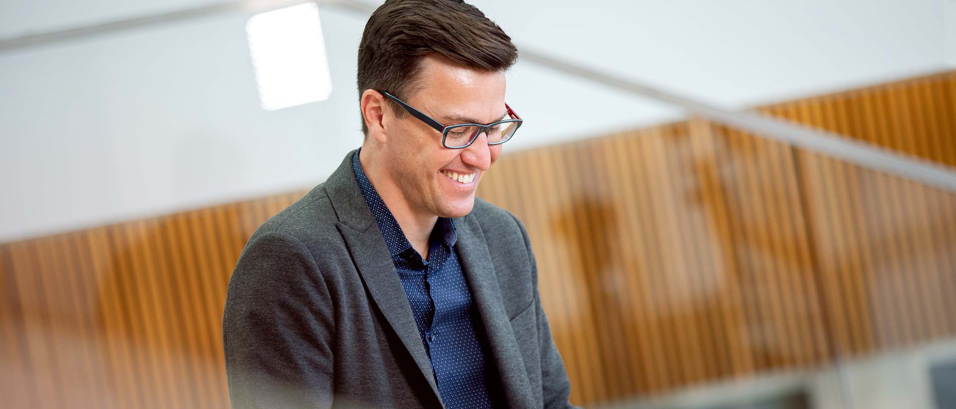 Professor in Management Brent Scott smiles inside the Broad College of Business