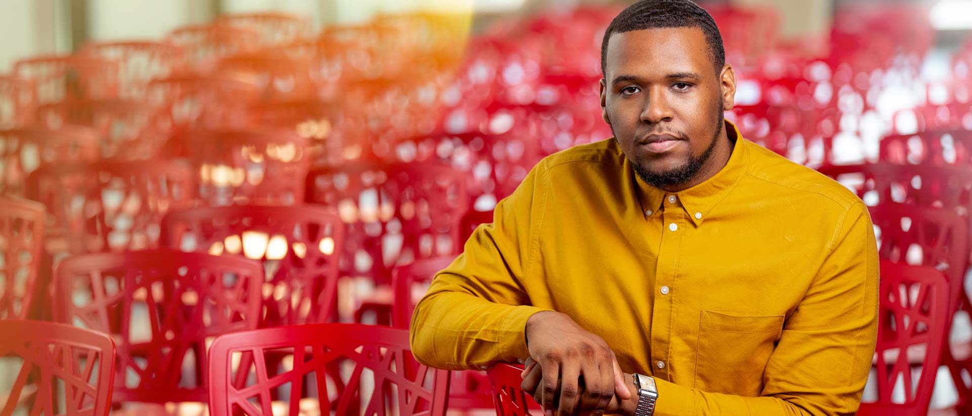 MSU and Broad College of Business Marketing alumnus Malik Amir Mix poses inside an auditorium in Detroit, MI