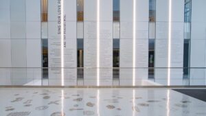 Zoom background set in the Lear Corporation Lobby facing the donor wall inside the Minskoff Pavilion