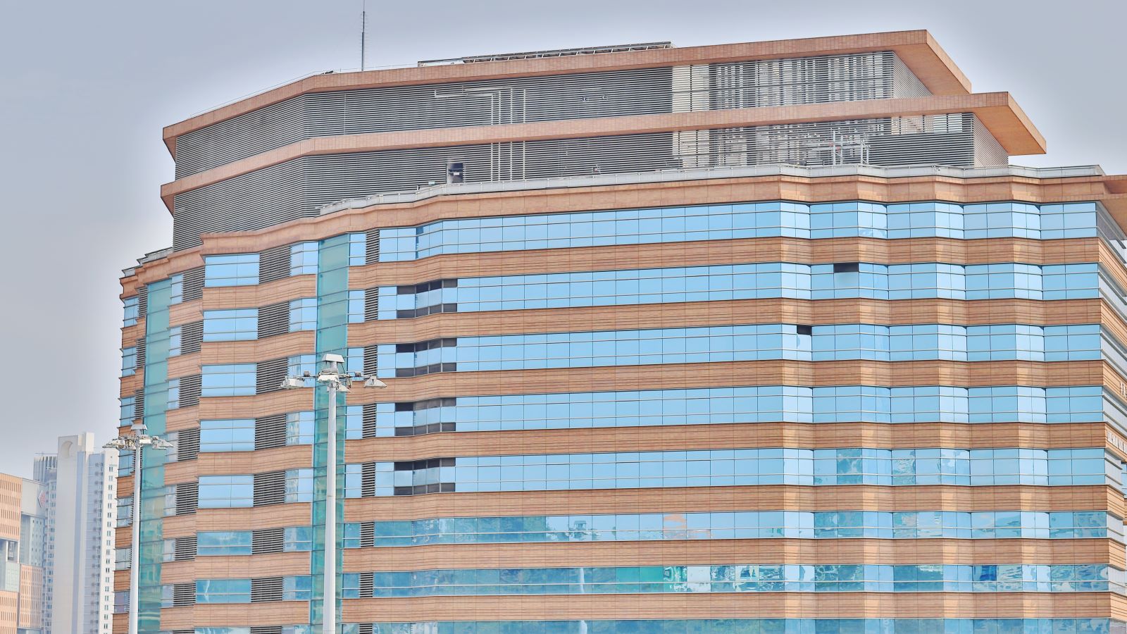 light blue and brown glass building at the Hong Kong Polytechnic University