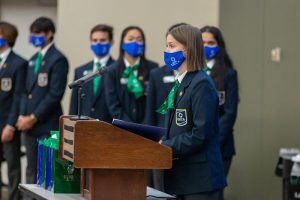Michigan DECA students speaking at a podium in the Broad College Complex; Michigan DECA is a nonprofit student organization, focusing on bettering and preparing students for the business industry. 
