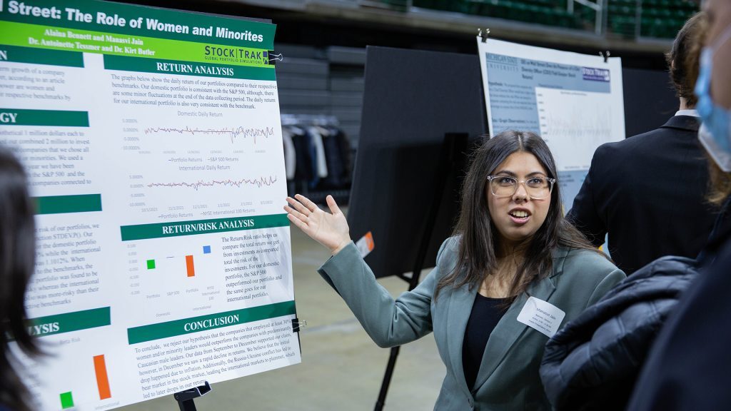 A student presents a research poster
