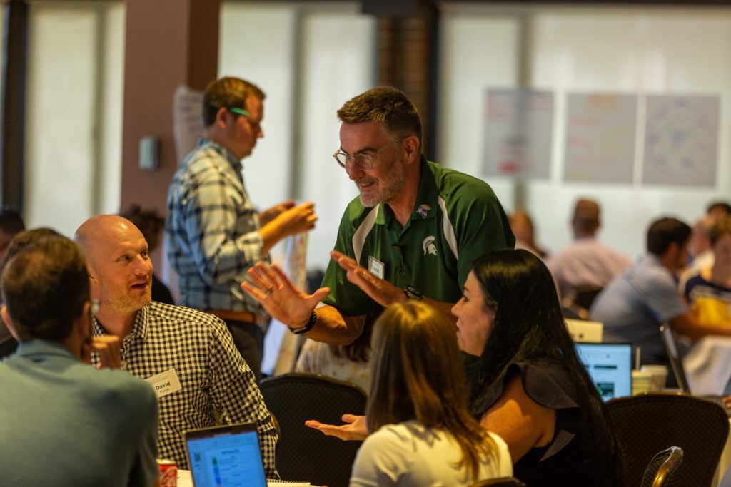 People talking and working together at orientation.