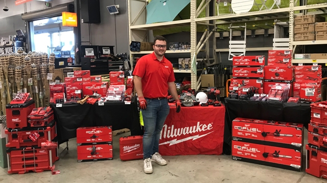 Braeden Furlow standing in front of table with Techtronic Industries tools wearing safety glasses and gloves