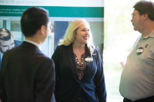 Broad M.S. in Marketing Research faculty chatting at an event in the Minskoff Pavilion.