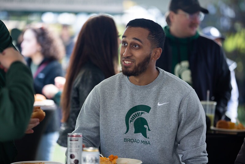 Man wearing Broad MBA sweatshirt at the 2022 MBA Homecoming tailgate.