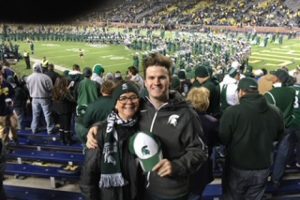 Ann Burnett and her son attend an MSU football game.
