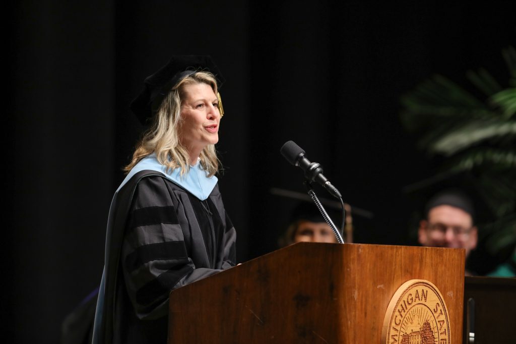 Cheri DeClercq, assistant dean for MBA programs, addresses Executive MBA graduates at commencement