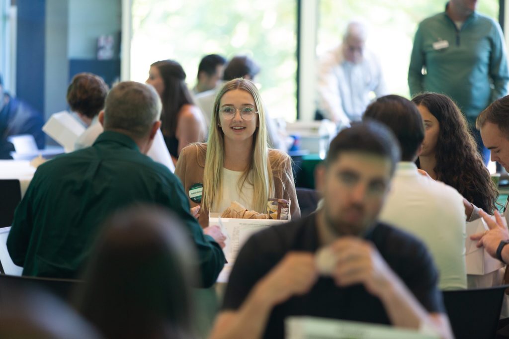 A young woman engaging with other attendees at the MSMR Spartan Insights Summit.