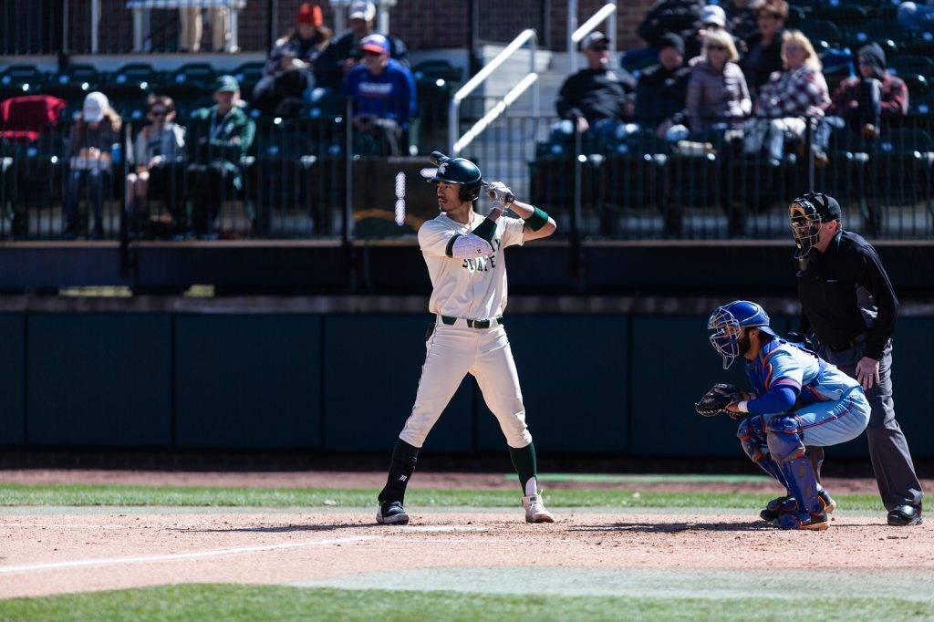 Peter Ahn at bat during a daytime baseball game, wearing home Spartan baseball uniform.
