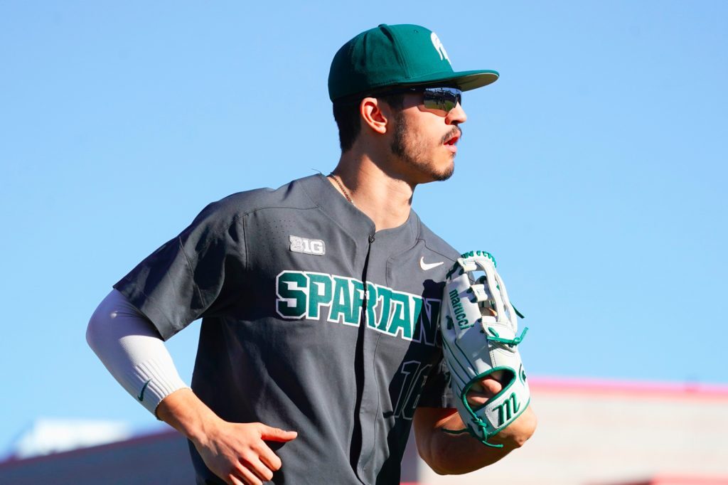 Close up of Peter Ahn running, wearing away Spartan baseball uniform.