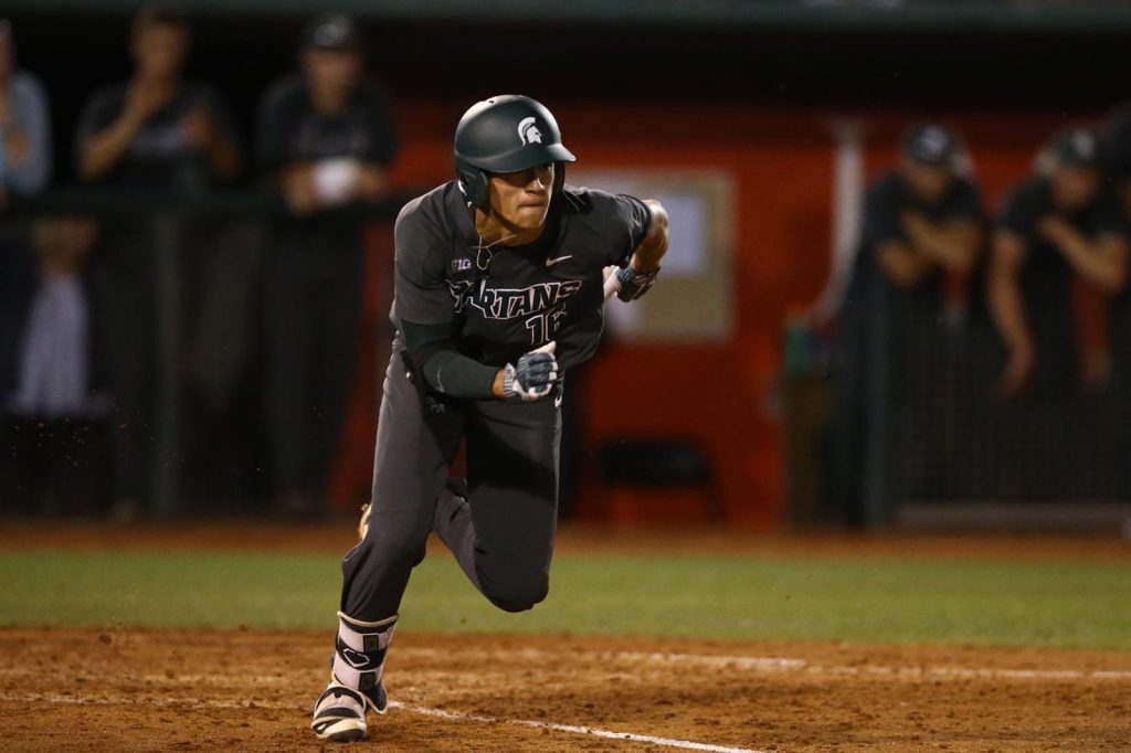 Peter Ahn running the bases at a night game, wearing away Spartan baseball uniform.