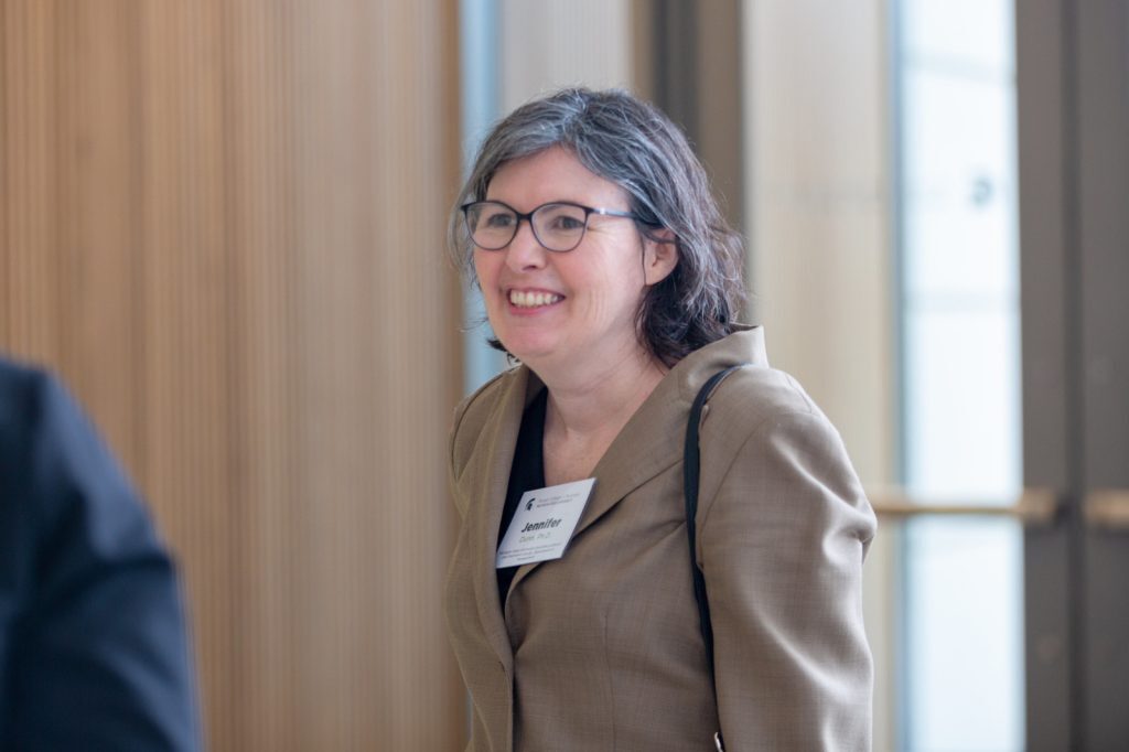 Jennifer Dunn smiles and walks in the Minskoff Pavilion.