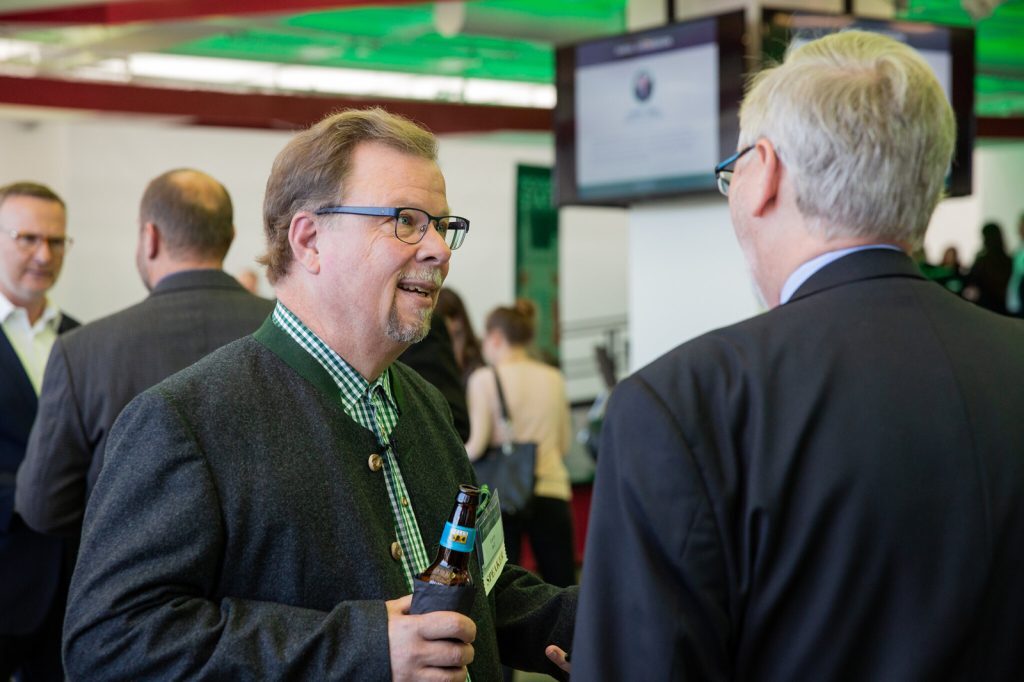 Larry Bell talks with another person at a Broad College event.