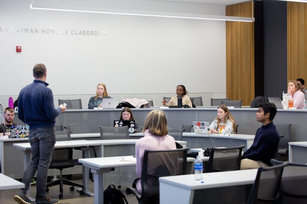 Mike Vichich presenting to a tiered classroom of students in the Minskoff Pavilion.