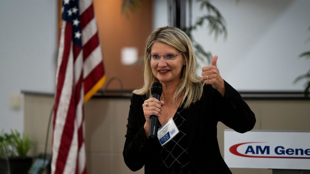Cheryl Thompson speaking into a microphone at an event.