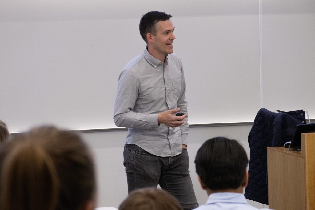 Doug DeMartin speaking in a classroom.