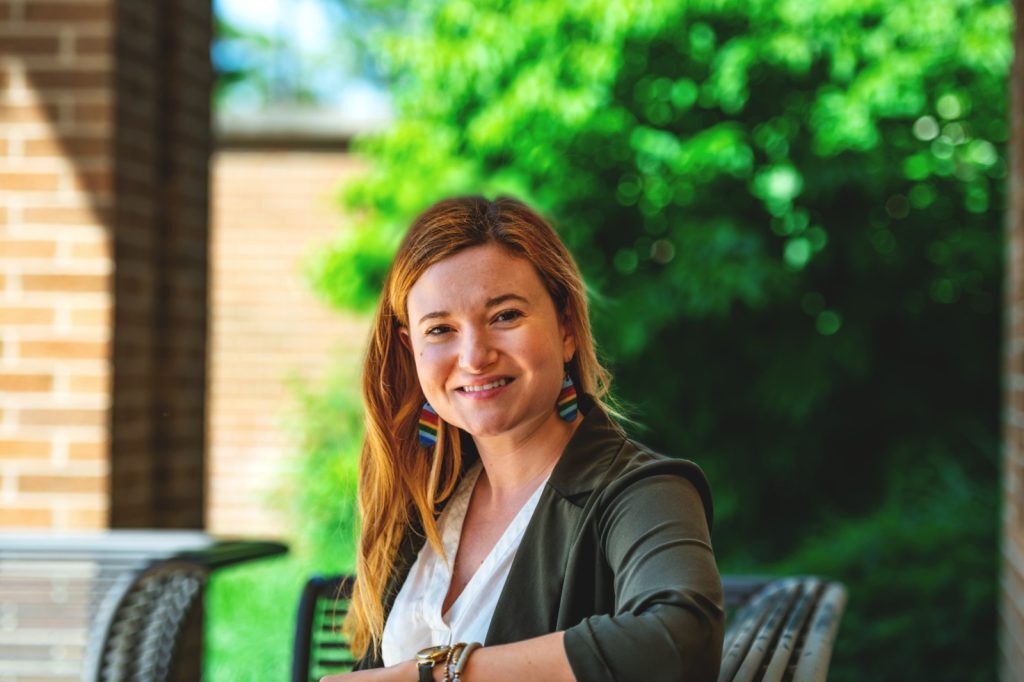 Kara Tripi sits outside on a bench