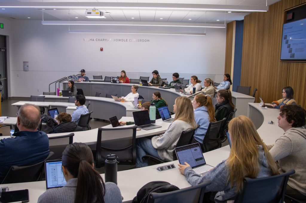 Students in a tiered classroom in the Minskoff Pavilion listen to a presentation.