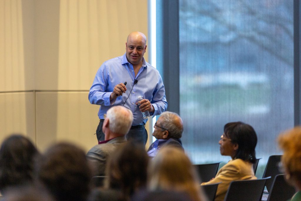 David Lanterman holds a microphone while presenting to a room of Broad faculty, staff and students.