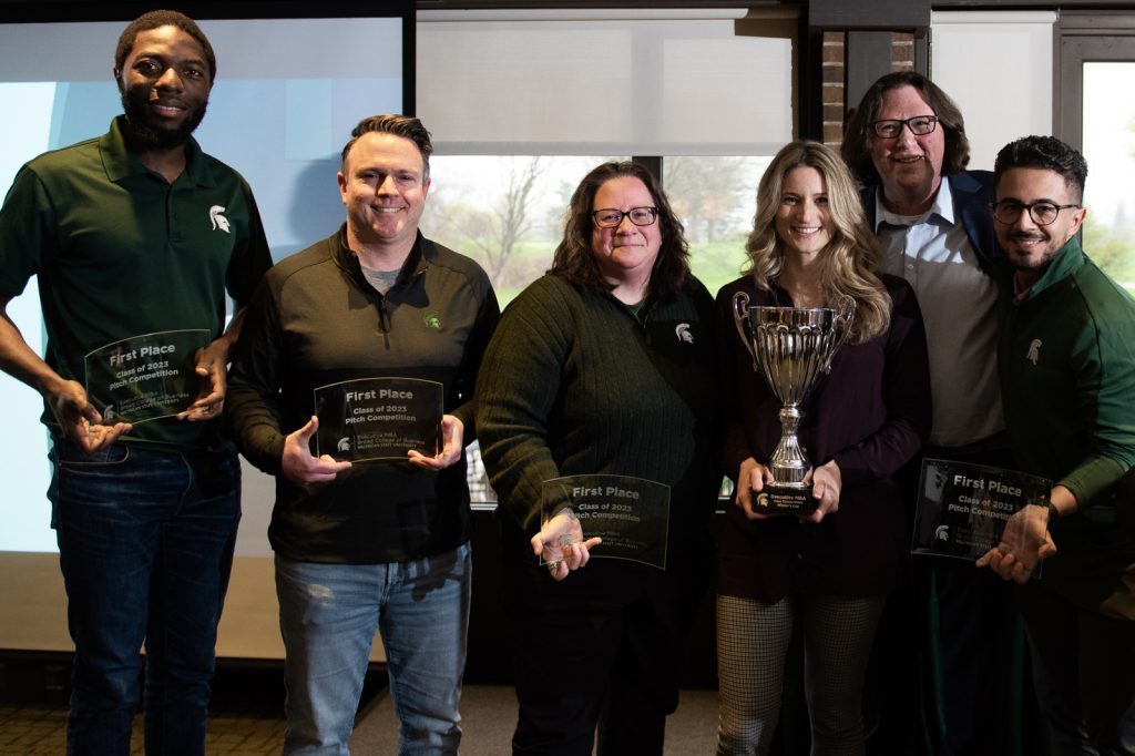 The 2023 EMBA Pitch Competition winners pose with plaques.