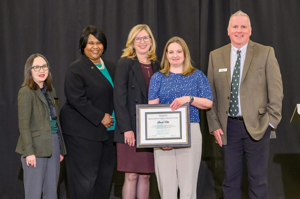 Sarah Ellis holds her award and poses with MSU interim president and other notable executives from the award committee. Photo credit: Dane Robison/TimeFramePhoto.