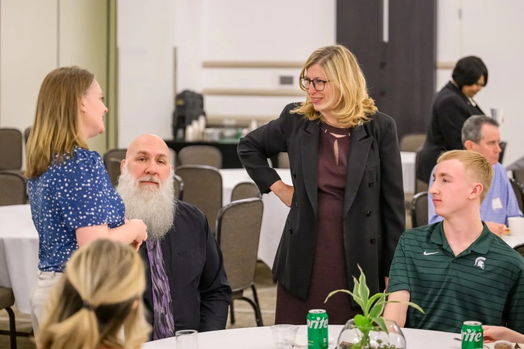 Sarah Ellis and her family talk with MSU interim president Teresa K. Woodruff during the award reception. Photo credit: Dane Robison/TimeFramePhoto.