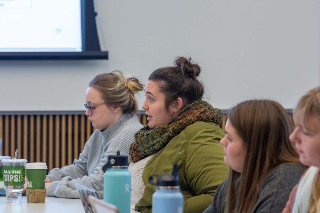 Broad students listen and take notes in class.