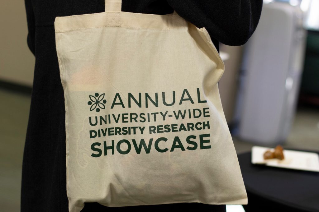 Close up of a beige tote bag that says 