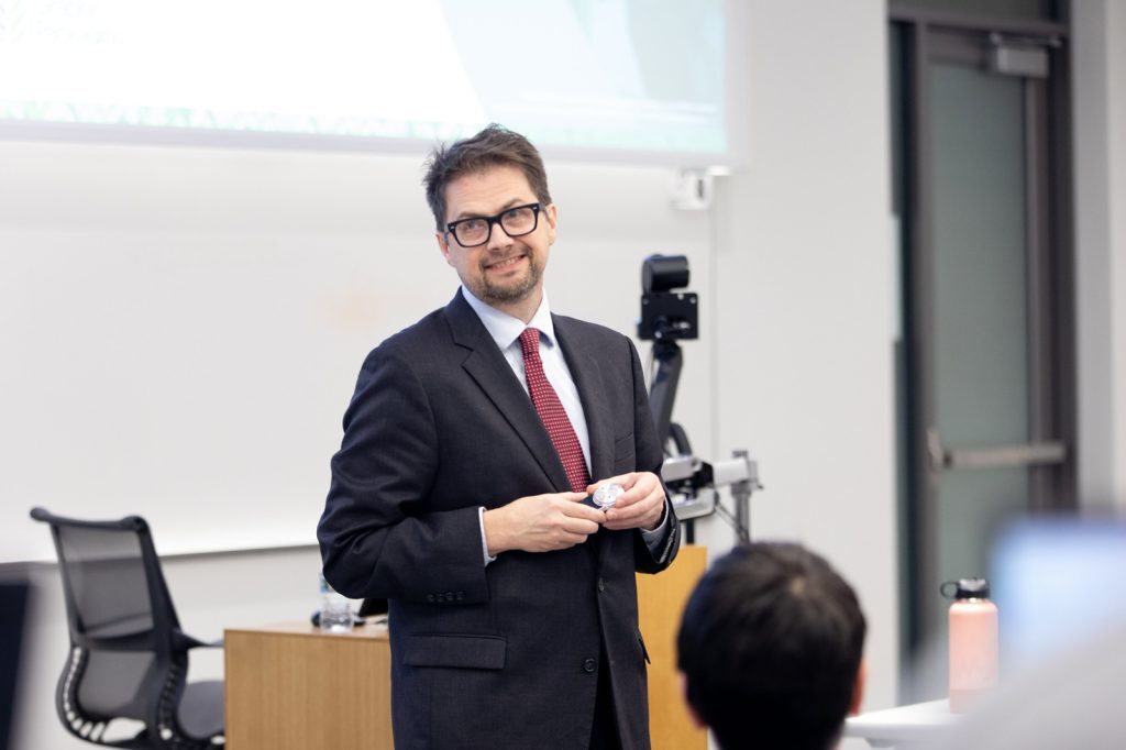 Joseph Yost speaking in a classroom.
