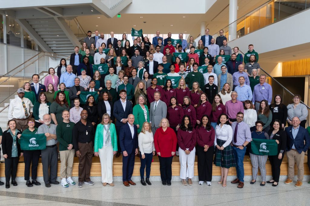 Broad faculty and staff fill the Minskoff Pavilion grand staircase for a photo with MSU President Guskiewicz.