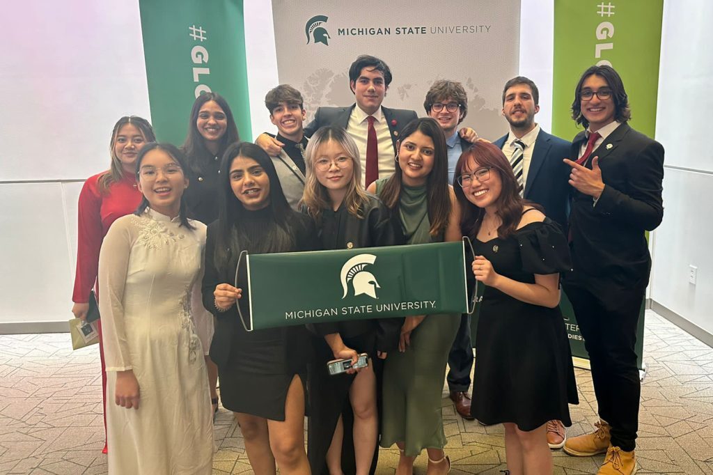 Group students with Spartan flag