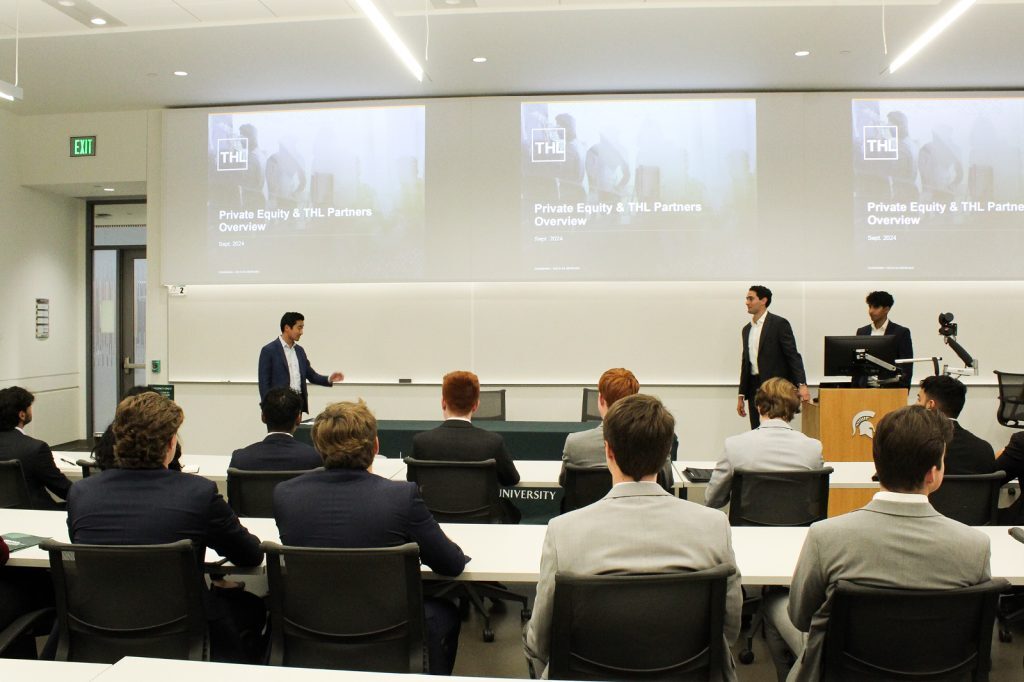 Students listening to a speaker talk in classroom