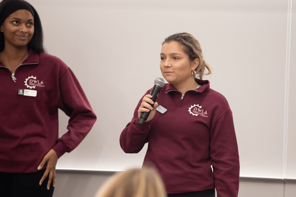 Students speaking to event attendees