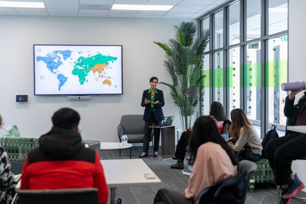 Diana Mejía speaking to seated event attendees