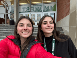 Two students smiling