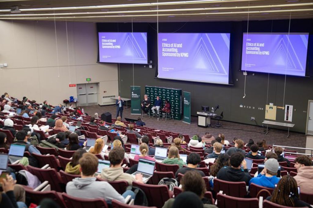 Group of speakers in front of an audience
