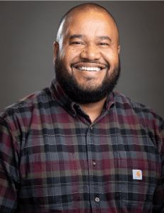 Professional headshot of Elisio Santos