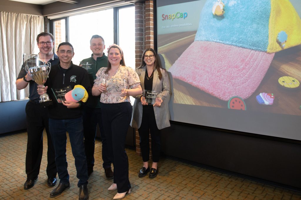 Group of EMBA students with their prize