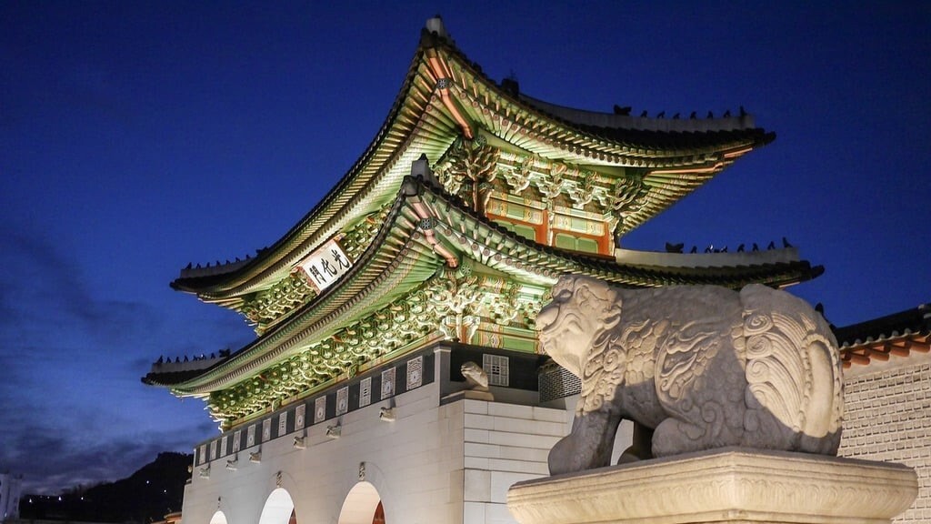 Night view of a temple and a lion statue in South Korea